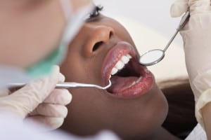 High angle view of female patient being examined by dentist in clinic